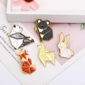 Cute geometric enamel badges featuring panda, koala, and fox animals on decorative background