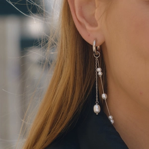 Asymmetric stainless steel pearl drop earrings with elegant long fringe tassels on model