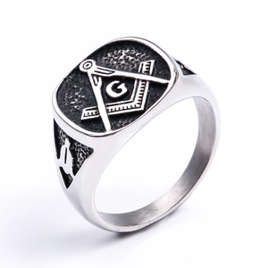 Detail view of Masonic Freemason compass symbol on black face of men's steel ring