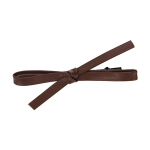 Minimalist brown leather bow hair clip with textured finish on a clean white background