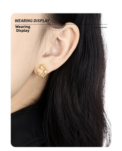 Close-up of S925 silver leaf wreath earrings with diamonds on a model's ear