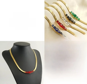 Detail of 18k gold plated snake chain necklace with five colors of square zircon stones