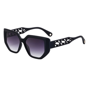 Cat eye sunglasses with hollow woven temples and gradient lenses shown at a 45-degree angle