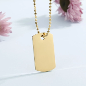 Polished gold rectangular dog tag pendant on a beaded chain with a reflective finish
