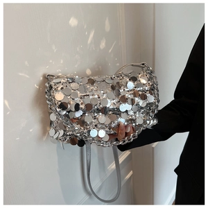 Detailed view of silver paillette handbag with metallic chain handle and sequins