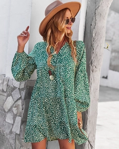 Detail of green V-neck lantern sleeve dress with white abstract polka dot print