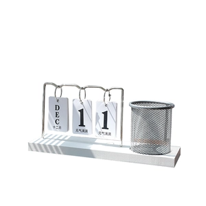 Minimalist white desktop calendar with metal mesh pen holder and flip-page date display