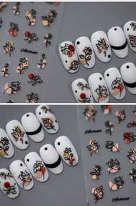 Macro detail of 5D embossed abstract floral nail art stickers on matte white nails