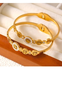 Detail shot of golden Tree of Life bangle with sparkling rhinestones in a jewelry box
