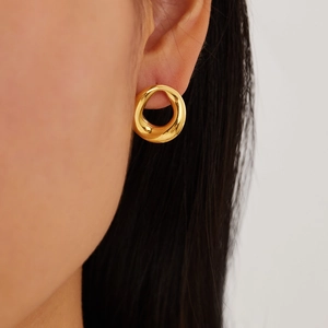Close-up of model wearing geometric gold-plated irregular hoop earrings in stainless steel