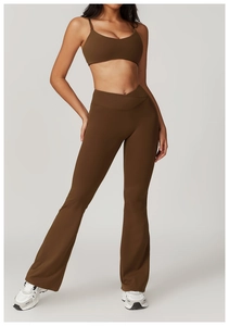 Detail of high-waisted flared yoga pants with V-shaped crossover waistband in dark brown