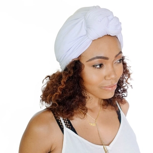 White knotted head wrap turban for women made of elastic fabric in a 45-degree side view