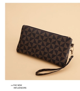 Detail view of stylish long clutch with geometric triangle pattern and gold zipper