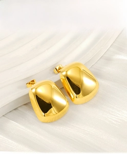 Detailed view of chunky golden square stud earrings with high-polish stainless steel finish