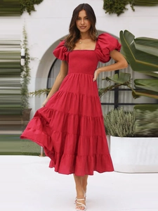 Detail of red off-shoulder floral dress with puff sleeves and layered tiered skirt