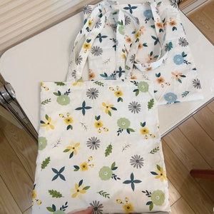 Detailed view of floral canvas tote bag with fresh yellow and blue flower patterns