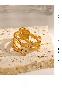 Close-up of golden multi-layer spiral ring on a natural stone textured display stand