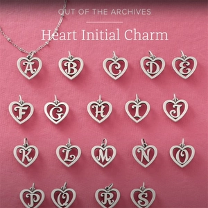 Cursive letter pendants in hollow heart shape made of polished stainless steel silver