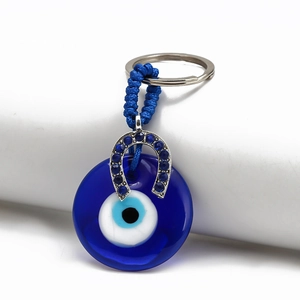Detailed blue evil eye keychain featuring horseshoe pendant with rhinestones on white background