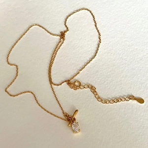 Minimalist 925 sterling silver gold necklace with oval zircon pendant on white background