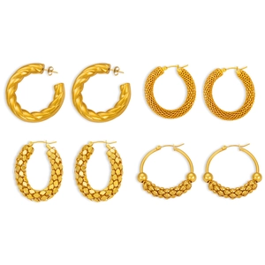 Set of four gold-plated U-shaped hoop earrings with textured and beaded designs