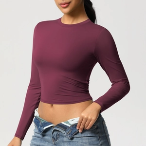 Détail d'un crop top de sport prune avec coupe ajustée élastique et manches longues