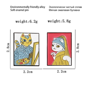 Detail view of cat enamel pins inspired by Van Gogh and Girl with a Pearl Earring