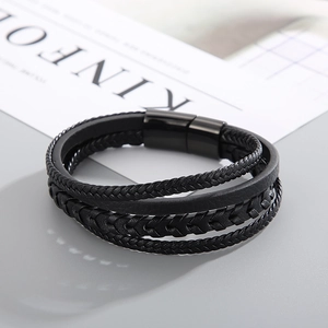 Detail of multi-layer black braided leather bracelet with matte black magnetic steel clasp