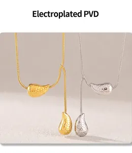 Macro detail of PVD plated water drop necklaces with hammered texture in gold and silver