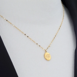 Elegant gold necklace with oval cat paw footprint pendant on a fine link chain for women