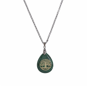 Detailed close-up of tree of life charm on green malachite teardrop stone pendant necklace