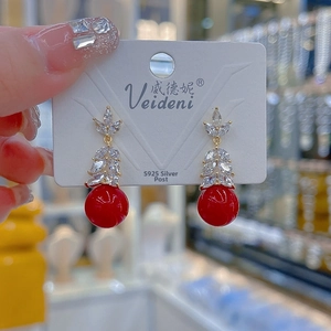 Close-up of leaf-shaped earrings with red beads and marquise zircon on S925 silver needles