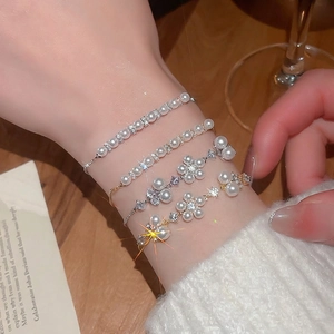 Luxurious French style pearl flower bracelet set with cubic zirconia and gold accents