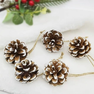 Natural brown pine cones with white tips on jute rope for Christmas tree decor