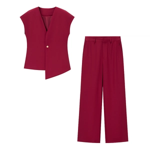 Detailed flat lay of burgundy two-piece suit set with asymmetric vest and wide-leg pants