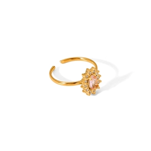Detail of adjustable gold sunflower ring featuring an oval pink zircon center stone