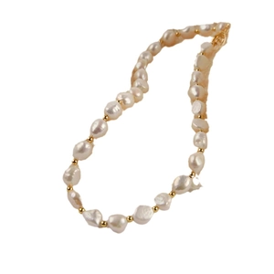 Elegant baroque pearl necklace with golden beads on a white background for a luxury look