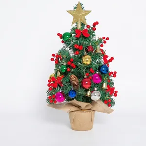 Mini tabletop Christmas tree with festive ornaments and rustic burlap base for holiday decor