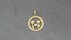 Detail of gold-plated pendant featuring diamond-encrusted boy and girl holding a heart