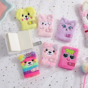 Detail of plush cartoon notebooks featuring animal embroidery and snap button closure
