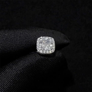 Macro shot of cushion-cut cubic zirconia stud earrings with halo setting on black background