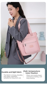Pink waterproof nylon tote bag detail with multiple pockets and adjustable shoulder strap