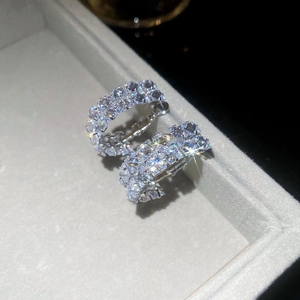 Close-up of silver-tone hoop earrings with pave-set sparkling cubic zirconia in a jewelry box