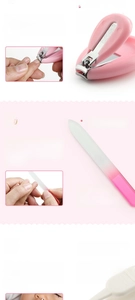 Close-up of pink baby nail clipper set with safety tweezers and fine grit file