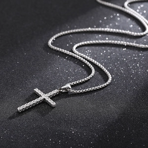 Men's titanium steel cross pendant necklace with sandblasted finish on a black background