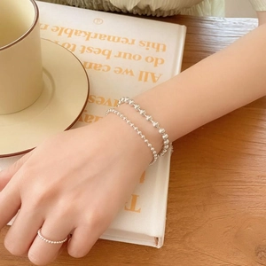 Minimalist S925 sterling silver 2mm bead bracelet and ring set for women on a cozy background