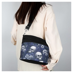 Detail of gothic skull and floral print crossbody bag with adjustable strap on model