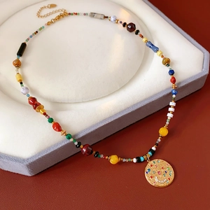 Κοντινή λήψη vintage κολιέ με χάντρες και χρυσό μενταγιόν χαμογελαστό πρόσωπο σε βάση
