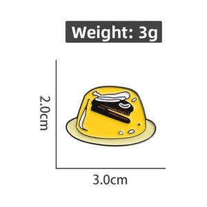 Detail of yellow pudding enamel pin showing weight 3g and size 3.0cm by 2.0cm