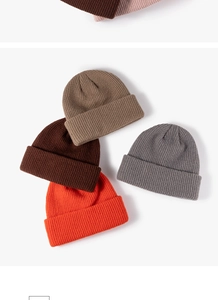Detailed shot of ribbed knit beanie hats in various colors, soft and cozy winter accessory.